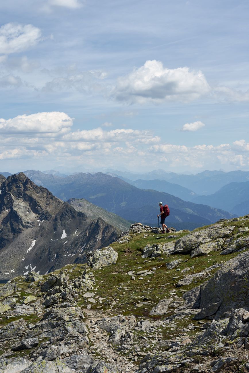 Hiker observing rugged mountain ridge